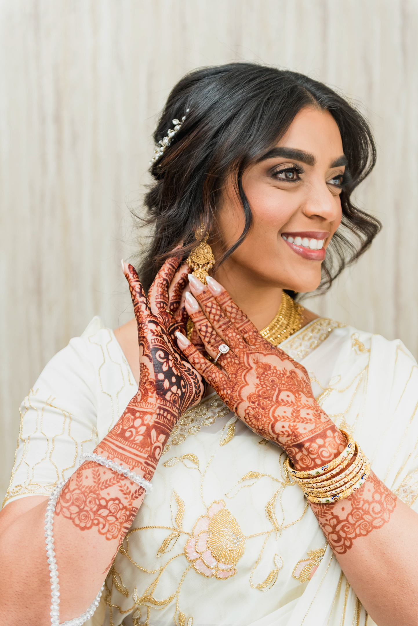 Bride and groom exchanging rings, henna visible on the bride's hands - Asim Studio, Toba Tek Singh